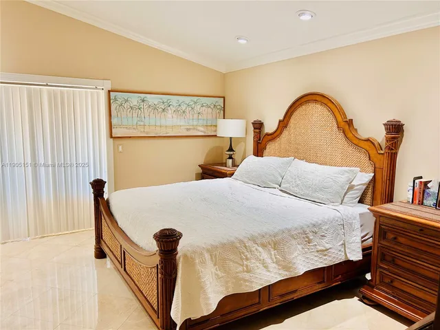 a bedroom with bed and a window