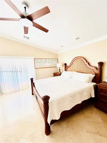 a spacious bedroom with a bed and a window