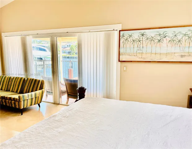 a spacious bedroom with a large bed and a window