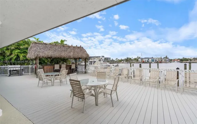 a view of a balcony with dining table and chairs