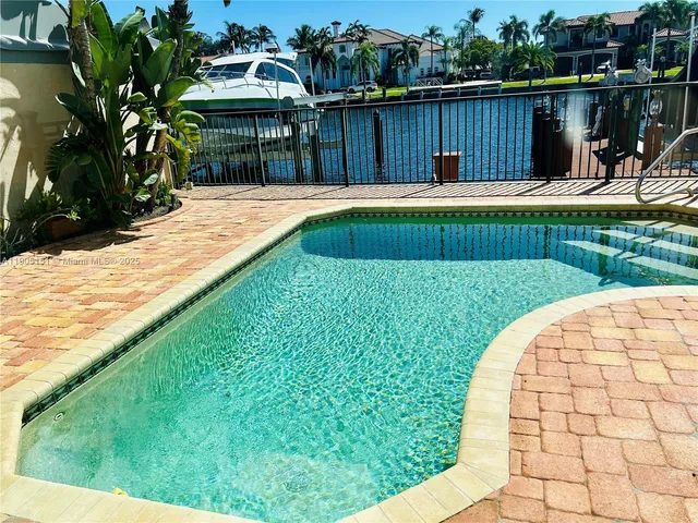 a view of a backyard with a barbeque grill and wooden fence
