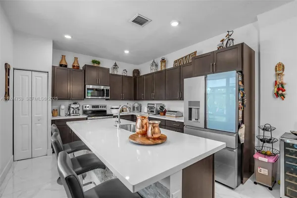 a kitchen with refrigerator and cabinets