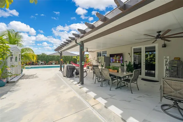 a view of a patio with table and chairs