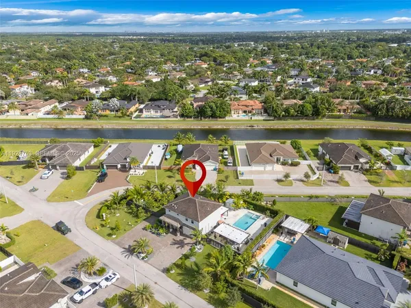 an aerial view of a house with a swimming pool