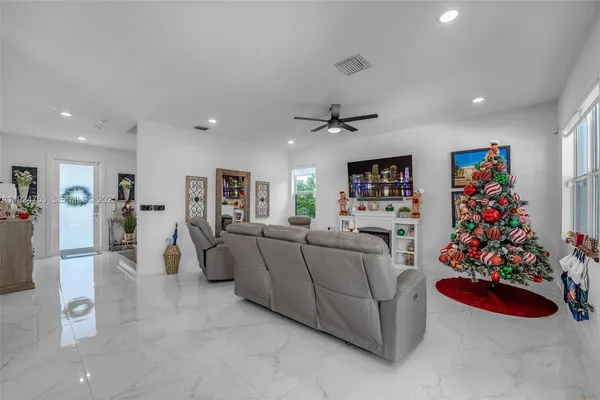 a living room with furniture and flowers
