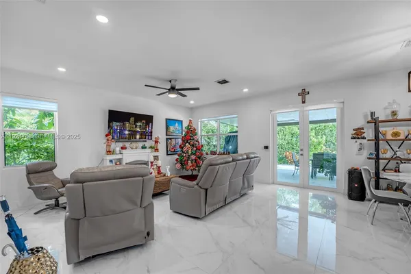 a living room with furniture and a large window