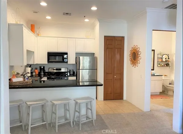 a kitchen with a refrigerator and a stove top oven