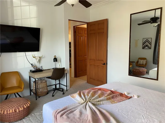 a bedroom with a bed and a flat screen tv