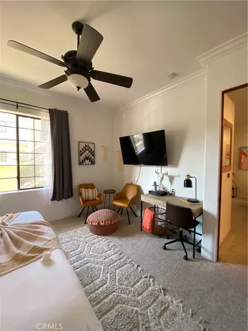 a bedroom with furniture or window and a ceiling fan
