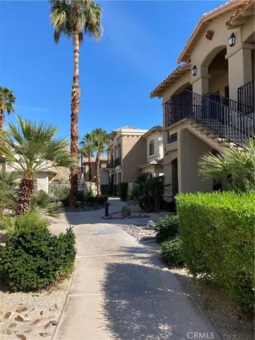 a front view of a house with a yard and potted plants
