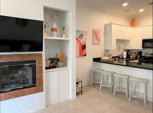 a kitchen with granite countertop white cabinets and stainless steel appliances
