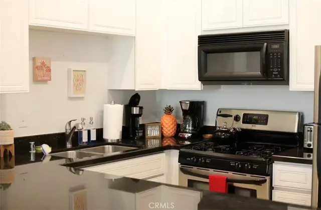 a kitchen with stainless steel appliances a stove a microwave and cabinets