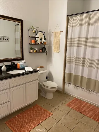a bathroom with a toilet a sink and a mirror