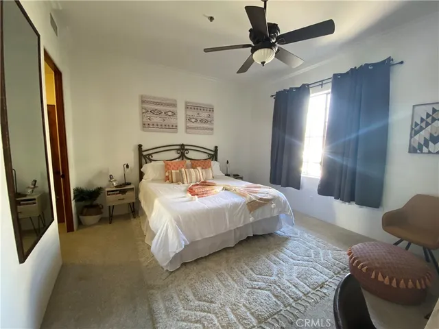 a bedroom with a bed and a large mirror