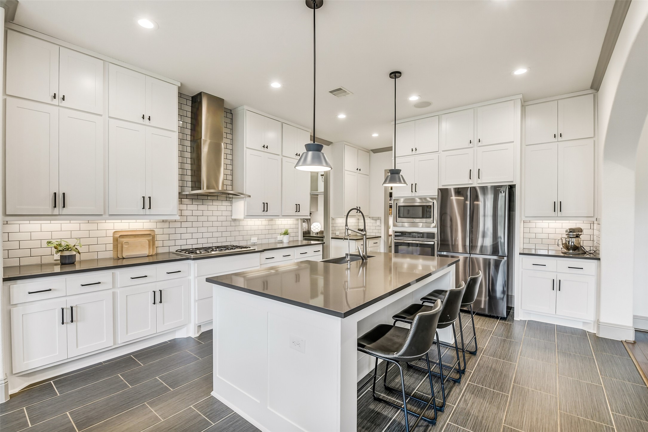 2430 Barclay Lake Lane Spring, TX 77388 - Photo 11 of 50 a kitchen with stainless steel appliances granite countertop a sink a stove a refrigerator and white cabinets with wooden floor