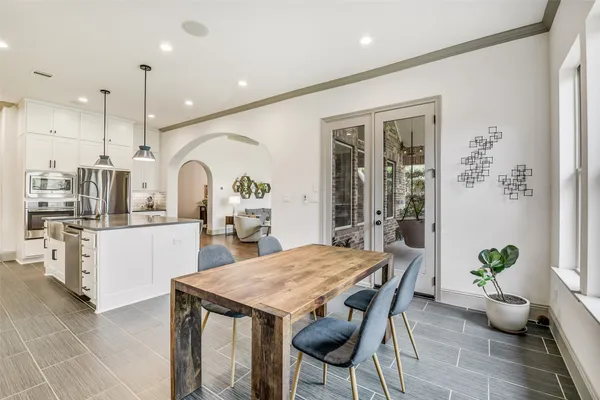 a living room with furniture and floor to ceiling window