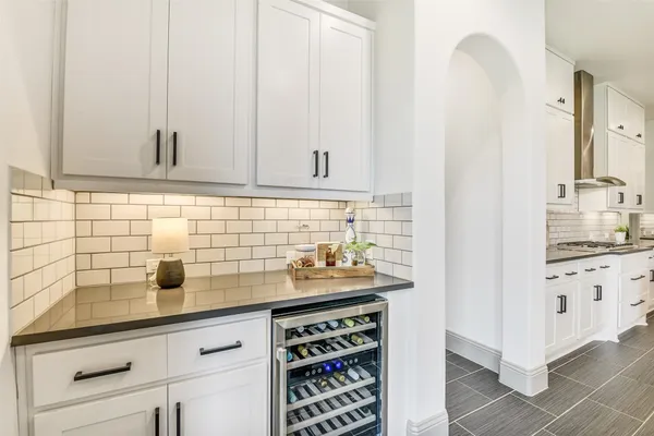 a living room with furniture and view of kitchen