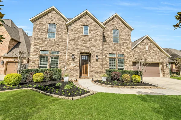 a front view of a house with a garden and porch