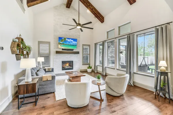 a living room with furniture a fireplace and a flat screen tv