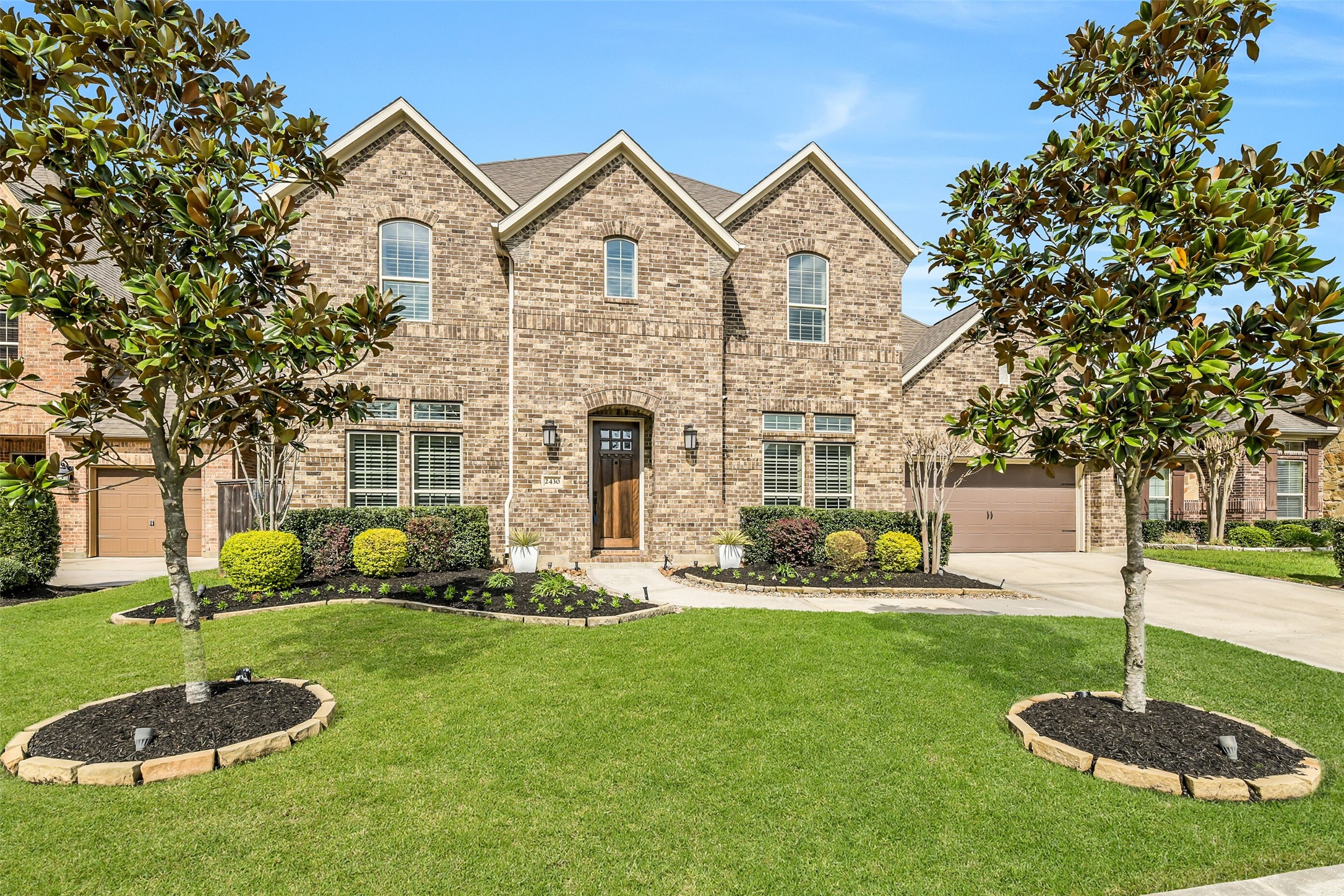2430 Barclay Lake Lane Spring, TX 77388 - Photo 6 of 50 a front view of a house with a yard garage and outdoor seating