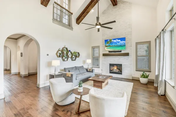 a living room with furniture a fireplace and a flat screen tv