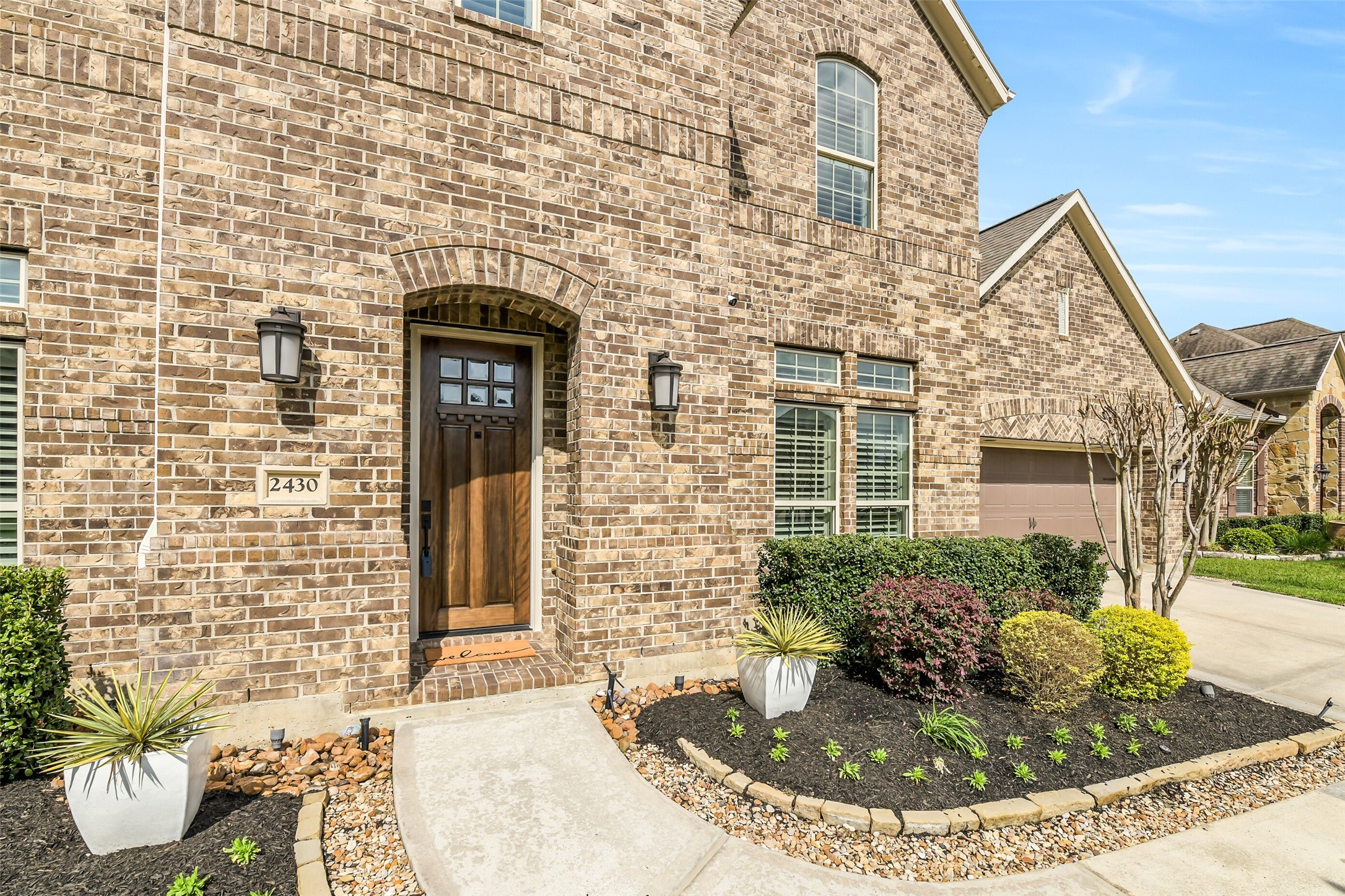 2430 Barclay Lake Lane Spring, TX 77388 - Photo 8 of 50 a view of a brick house with potted plants