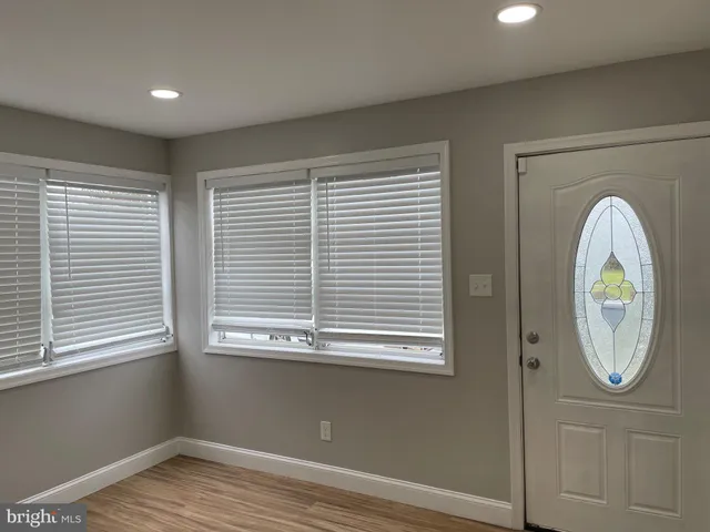 wooden floor in a room next to a window