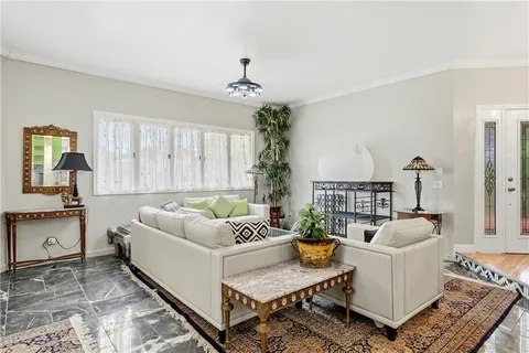 a living room with furniture and a chandelier