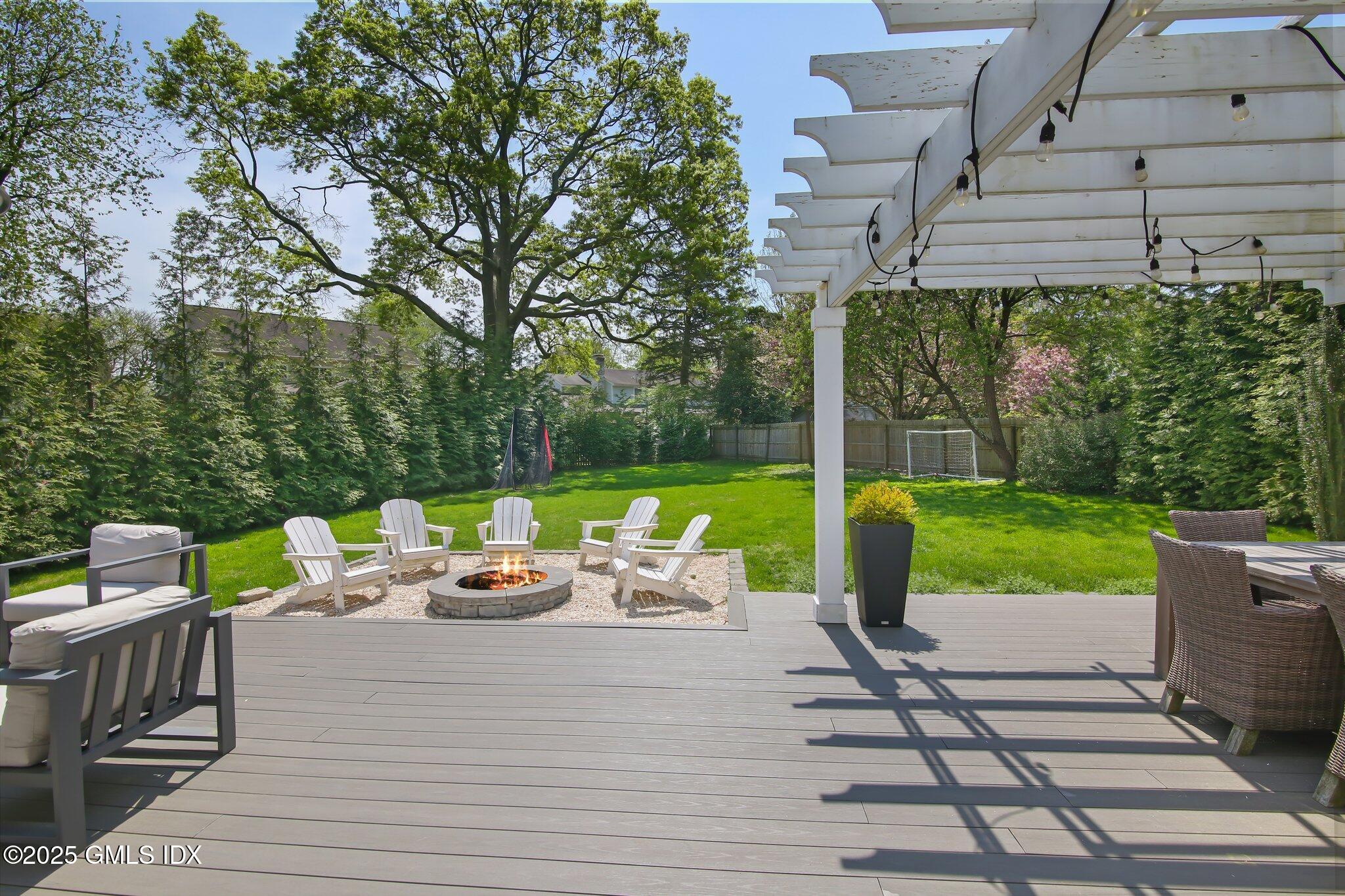 41 Rainbow Drive Riverside, CT 06878 - Photo 3 of 7 a view of a patio with lawn chairs next to a yard