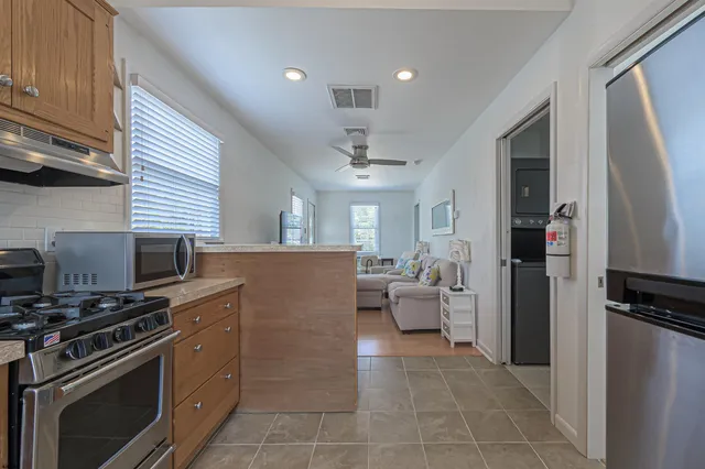 a kitchen with a sink stainless steel appliances and cabinets