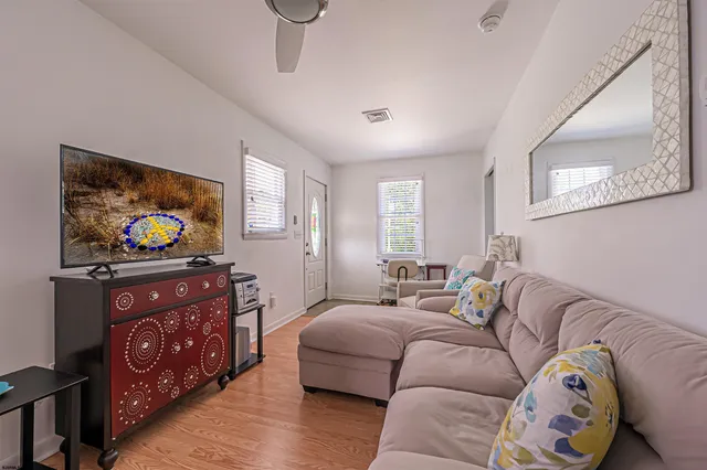 a bedroom with furniture and a flat screen tv