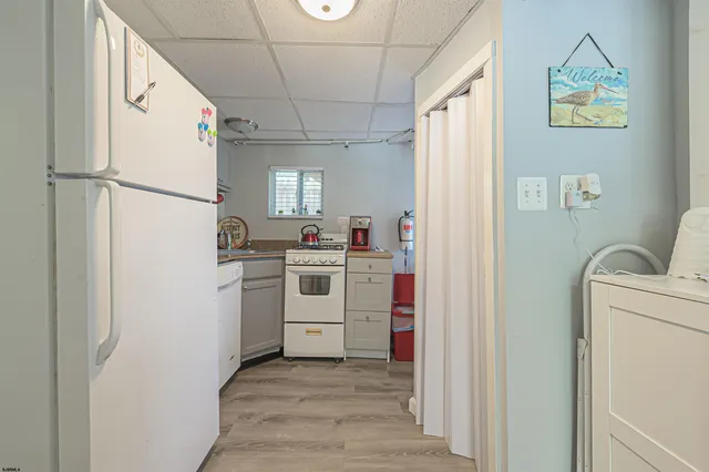 a utility room with cabinets washer and dryer
