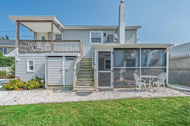 a front view of a house with a yard table and chairs