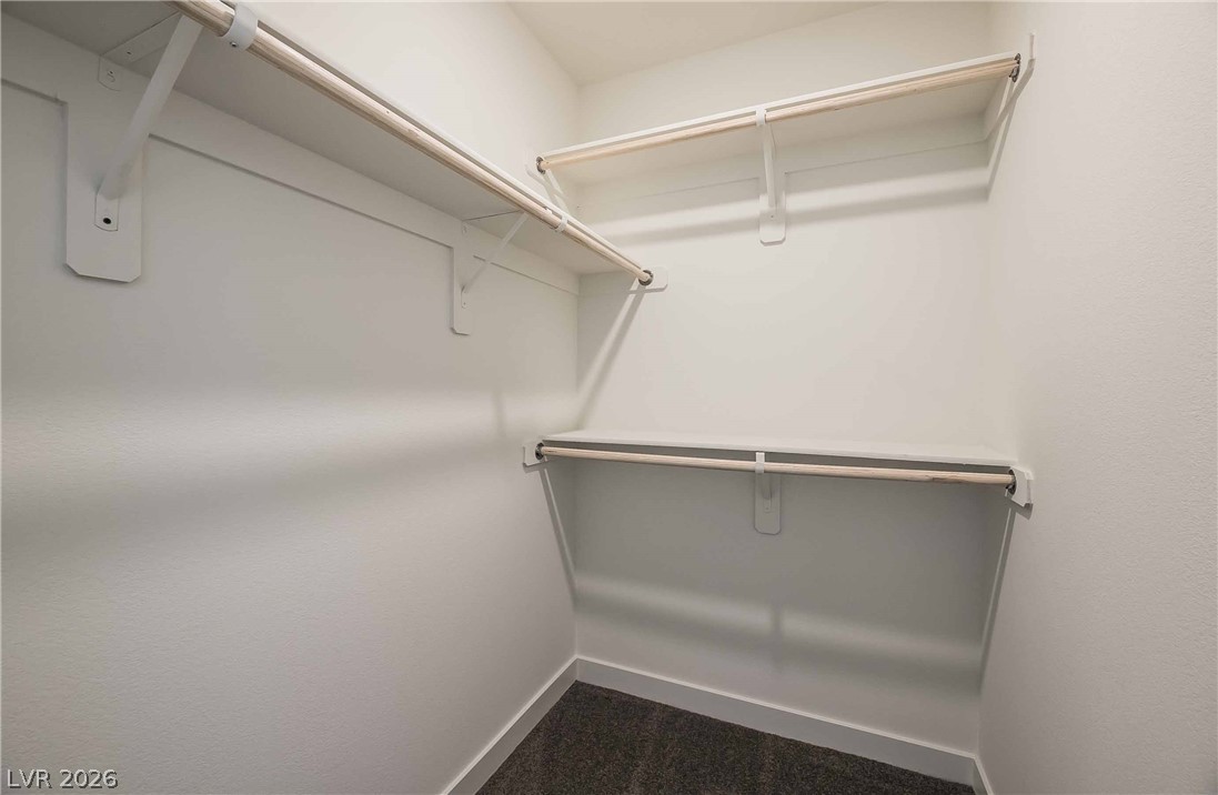 12749 Epperly Street Henderson, NV 89044 - Photo 11 of 22 Well-organized closet space featuring multiple levels of shelving and hanging rods for ample storage.