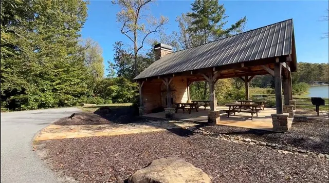 a view of house with backyard and outdoor seating