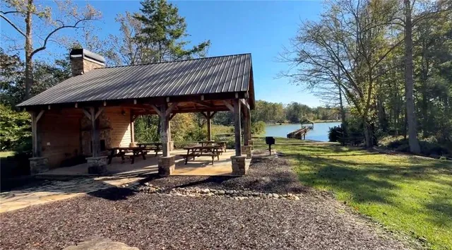 a view of a patio with a table chairs and a fire pit