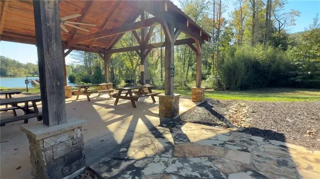 a view of swimming pool with lawn chairs and patio