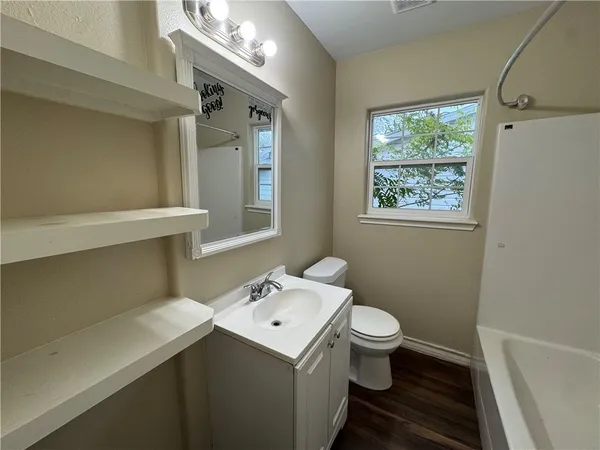 a bathroom with a sink toilet and a mirror