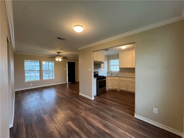 a view of kitchen with sink and wooden floor