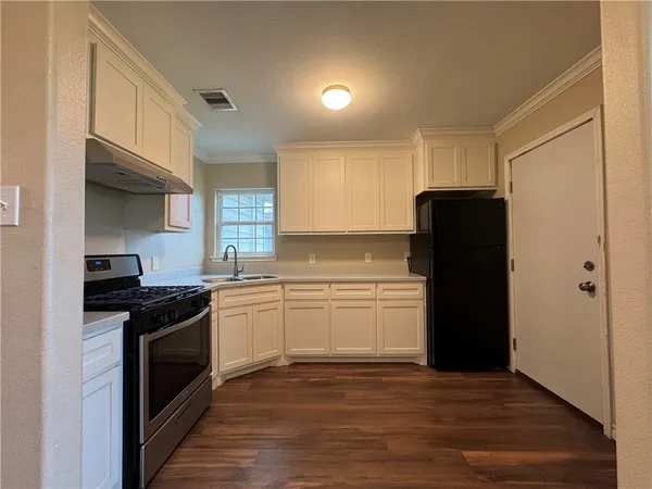 a kitchen with a refrigerator stove and sink