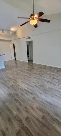 a view of a room with wooden floor