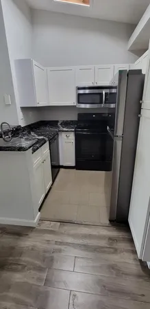 a kitchen with a stove a refrigerator and a sink
