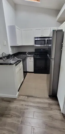a kitchen with a stove and a refrigerator