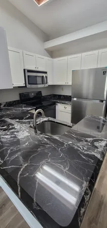 a kitchen sink with granite countertop