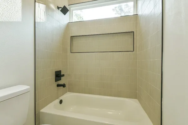 a bathroom with a bathtub and a toilet