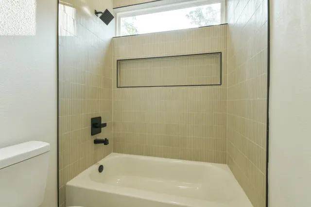 a bathroom with a sink vanity mirror and toilet