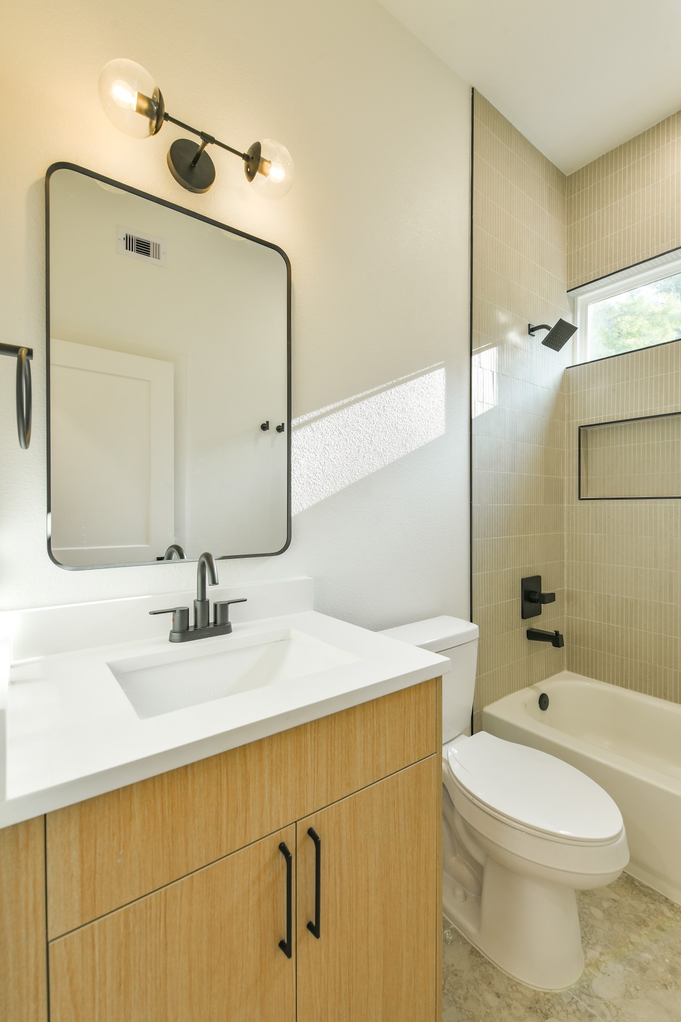 162 Wallace Street, Unit B Houston, TX 77022 - Photo 22 of 25 a bathroom with a sink vanity mirror and toilet