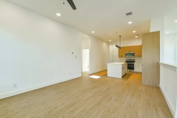 a view of a kitchen with a sink and wooden floor