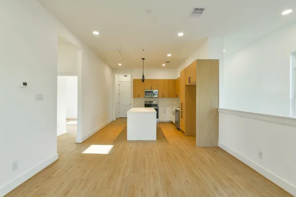a view of a kitchen with a kitchen and a wooden floor