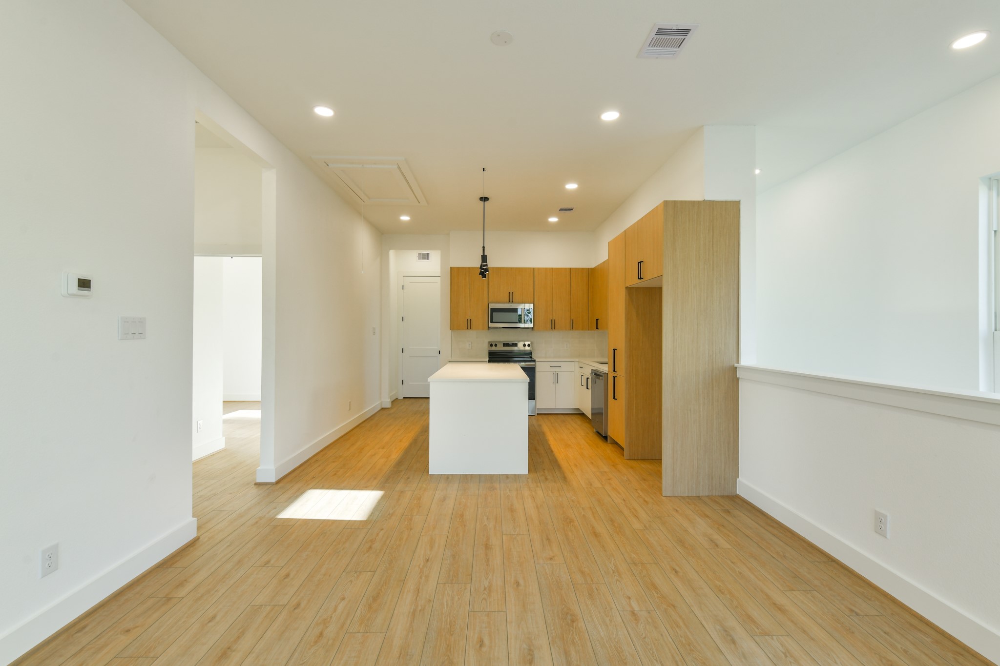162 Wallace Street, Unit B Houston, TX 77022 - Photo 7 of 25 a view of a kitchen with a kitchen and a wooden floor